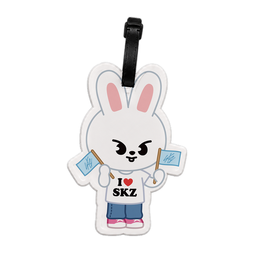 Luggage tag shaped like a cartoon rabbit holding flags with text 